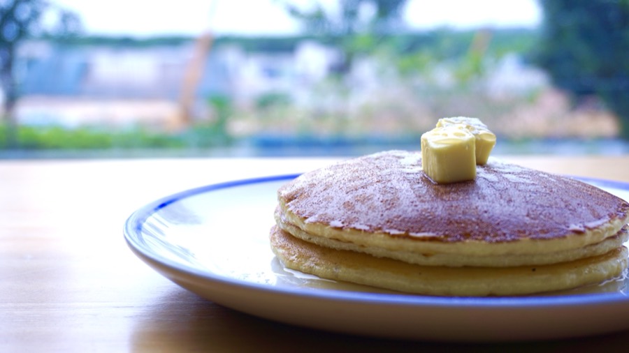 Classic pancake stack with butter and maple syrup at 209 Cafe
